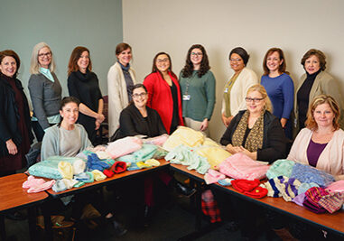 Healthy MOMS team at a table with donated clothing